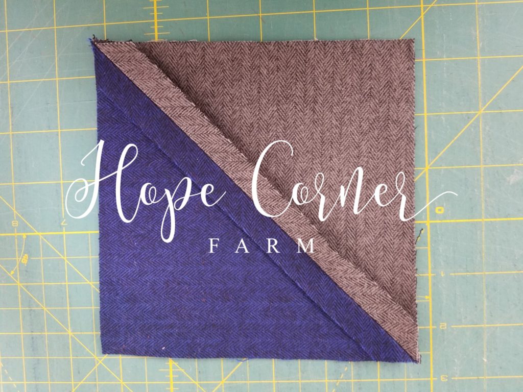 The seam of the half square triangle pressed open Hope Corner Farm