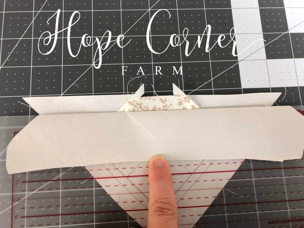 Preparing to trim the excess fabric in paper piecing Hope Corner Farm