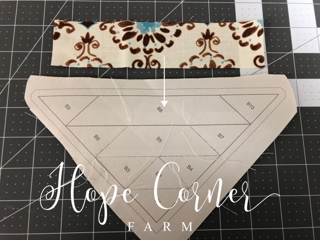 Adding piece eight in paper piecing Hope Corner Farm
