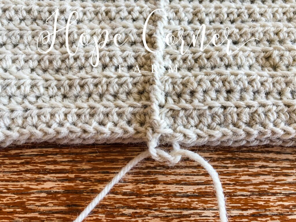 Tying a knot in the wide cinch crochet headband