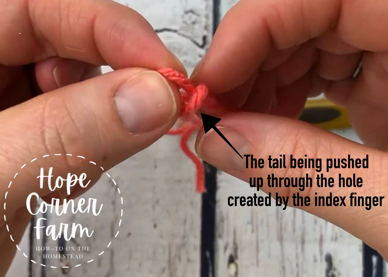 Grab onto the slip knot as it comes through the hole