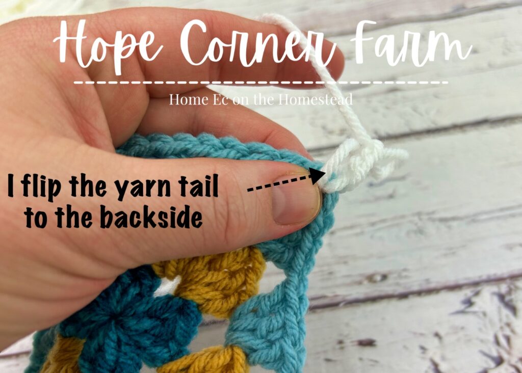 pushing the yarn tail to the backside