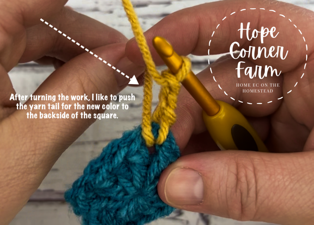 Push the yarn tail to the backside of the granny square