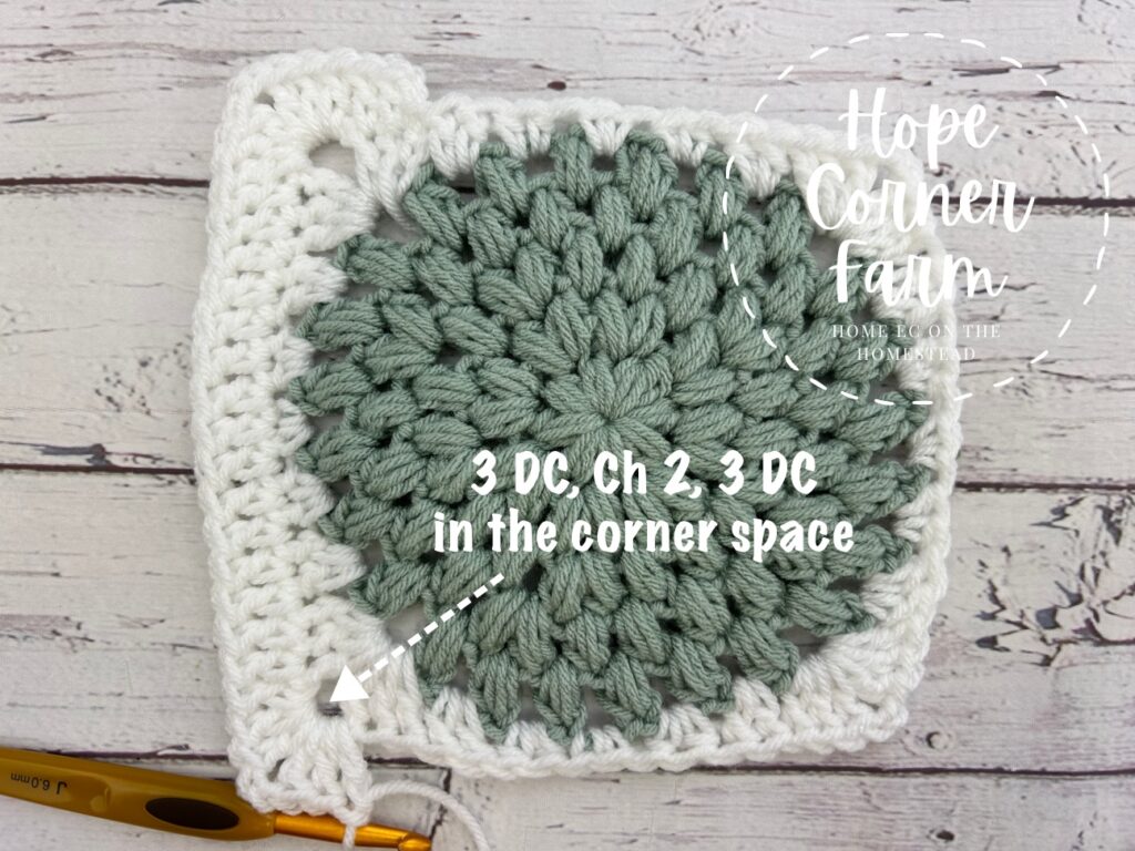 crocheting the second corner of the crochet puff stitch granny square