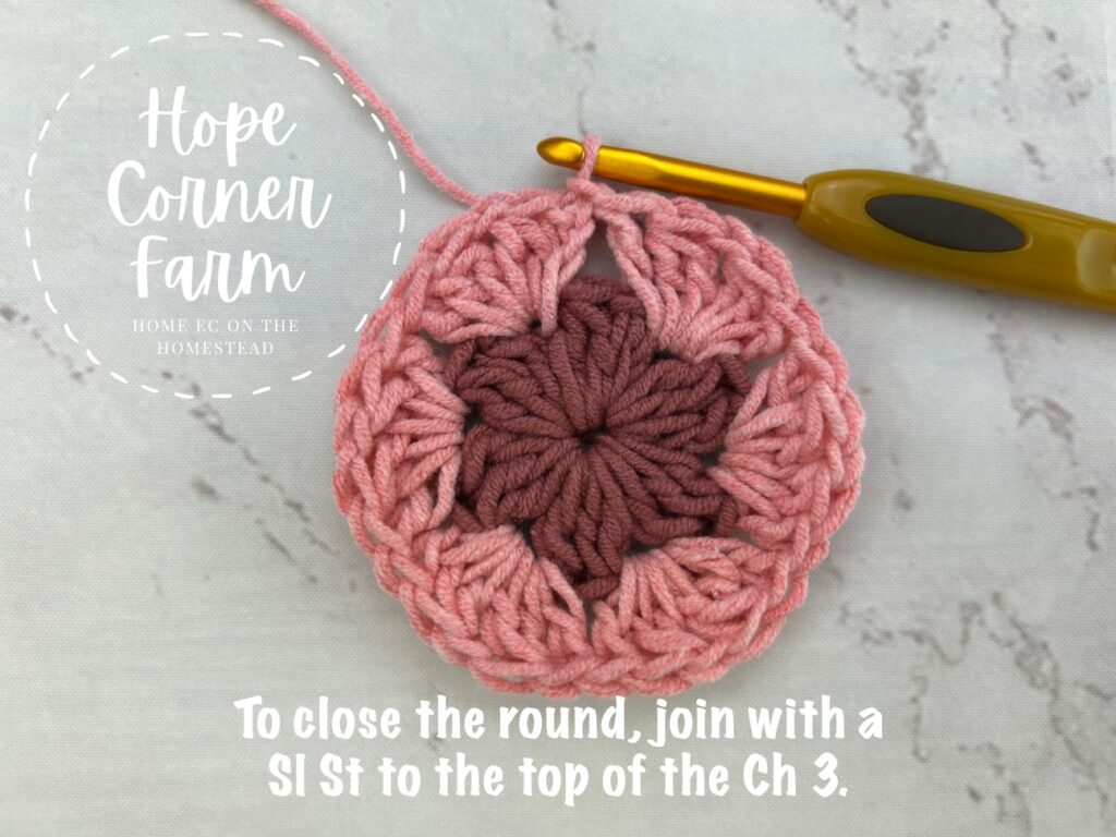 To close round 2 of the crochet hexagon, join with a slip stitch to the top of the chain 3.