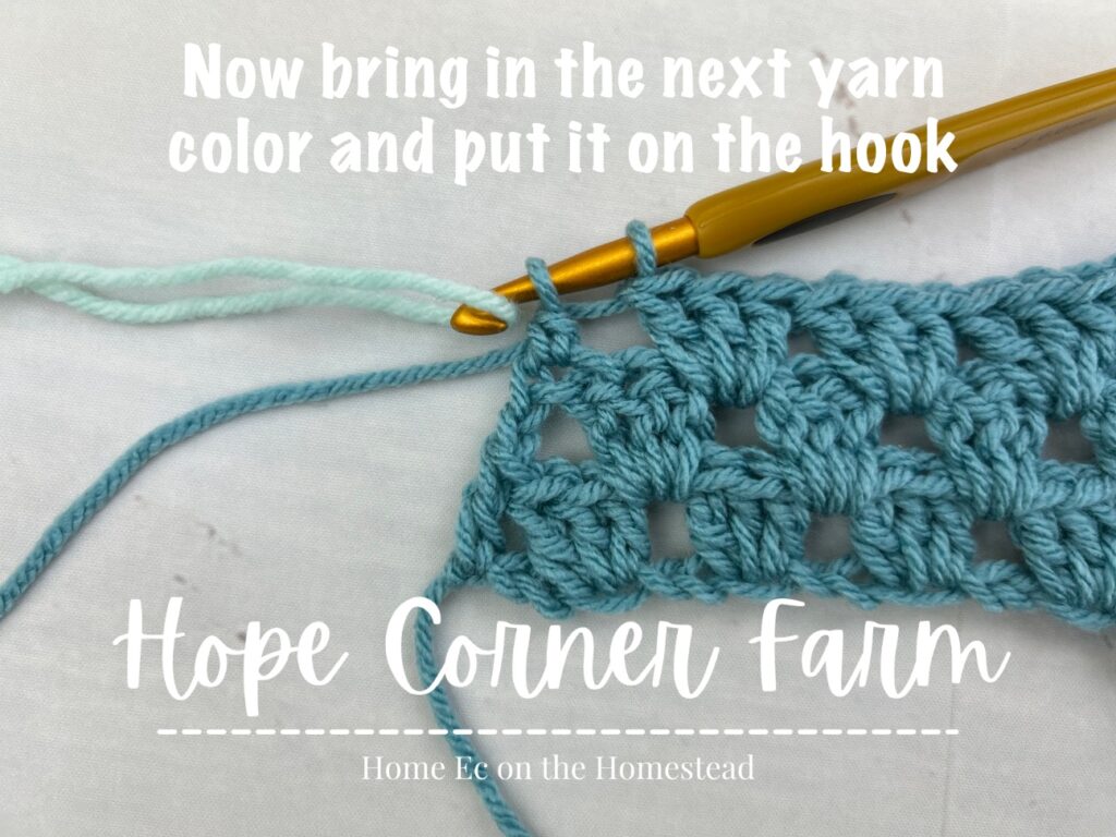 With new yarn color YO and pull through both loops