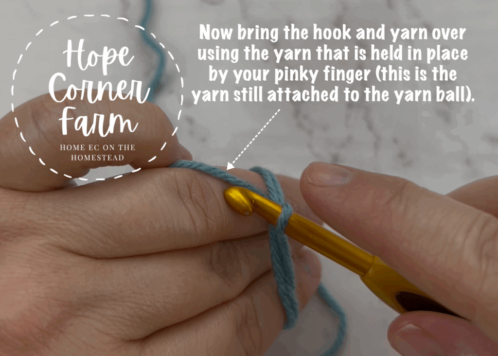 Bring the crochet hook and yarn over using the yarn held in place by the pinky finger