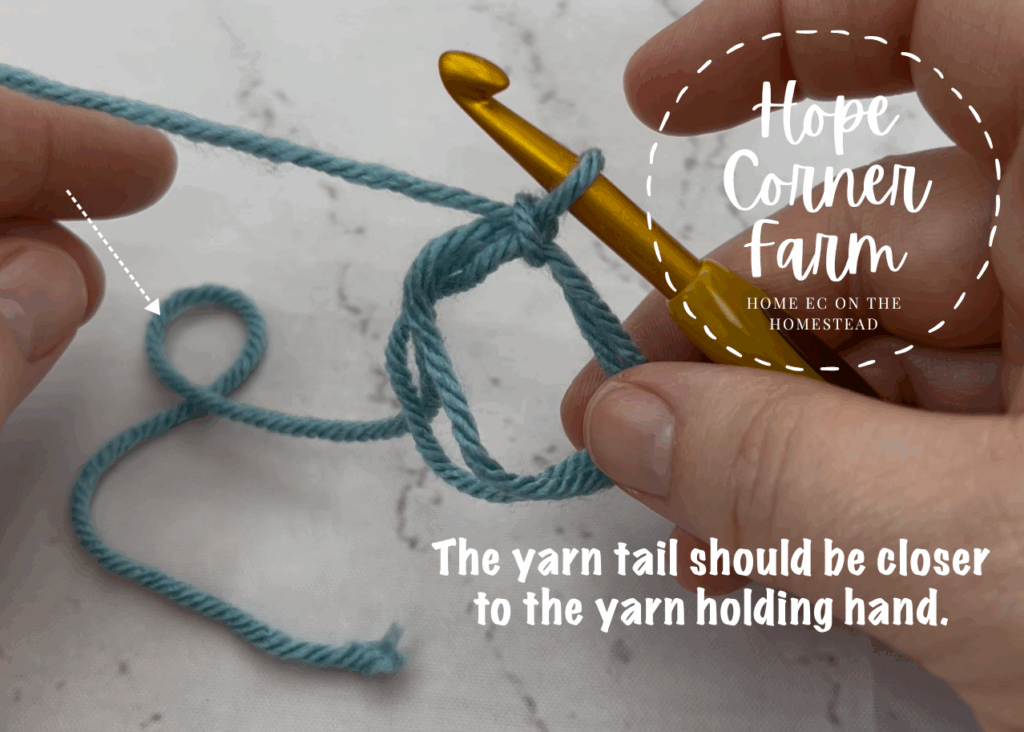 The yarn tail should be closer to the yarn holding hand