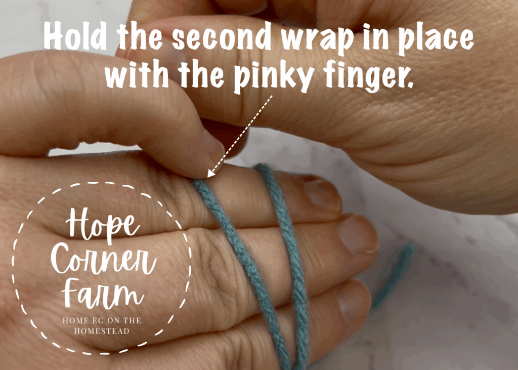 Hold the second wrap in place with the pinky finger
