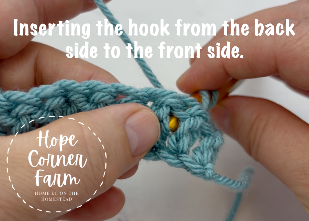 Inserting the crochet hook from the back side to the front side.