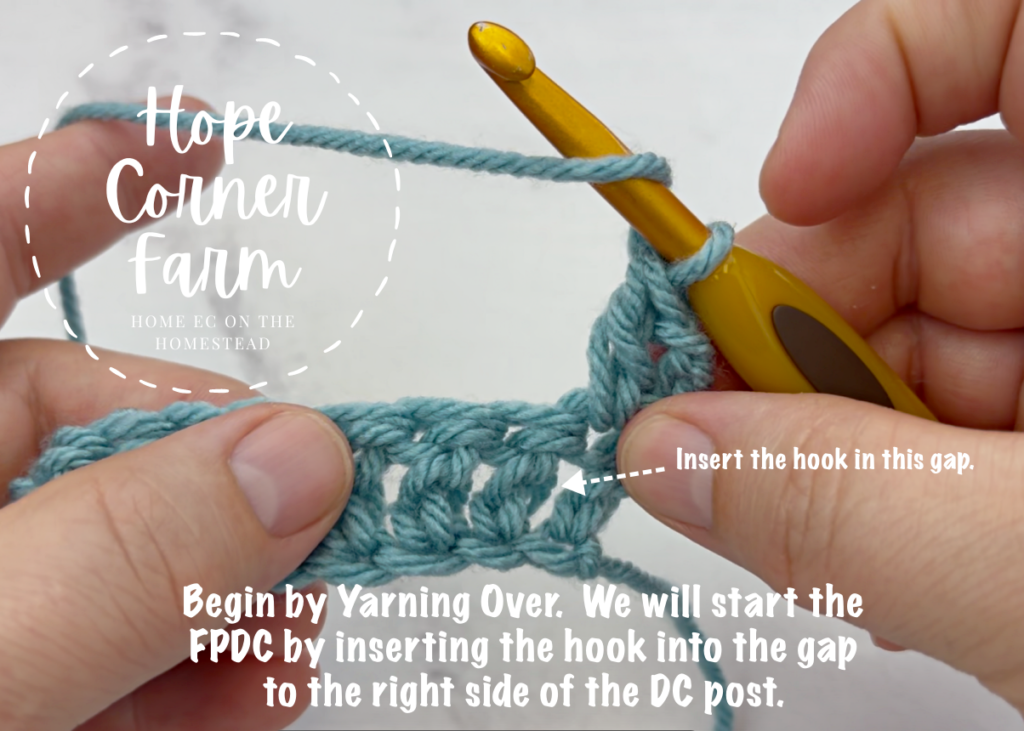 Begin by yarning over. Start the FPDC by inserting the hook into the gap to the right of the post