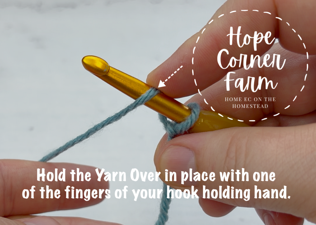 Hold the yarn over in place with on of the fingers of your hook holding hand